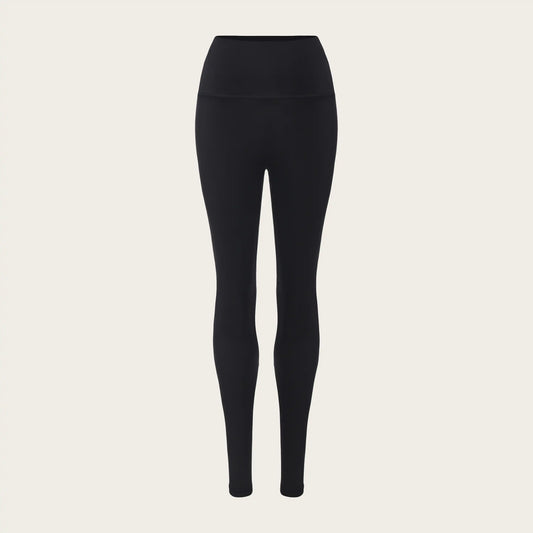 Unstoppable Collective Black leggings on a beige background