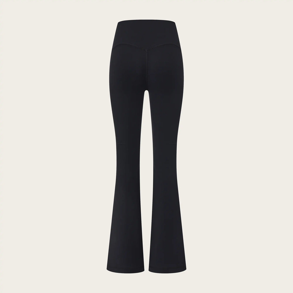 Black flared pants on a beige background
