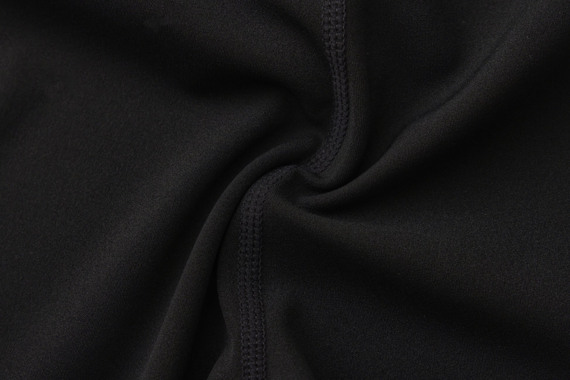 Close-up of black fabric with a focus on texture and stitching.
