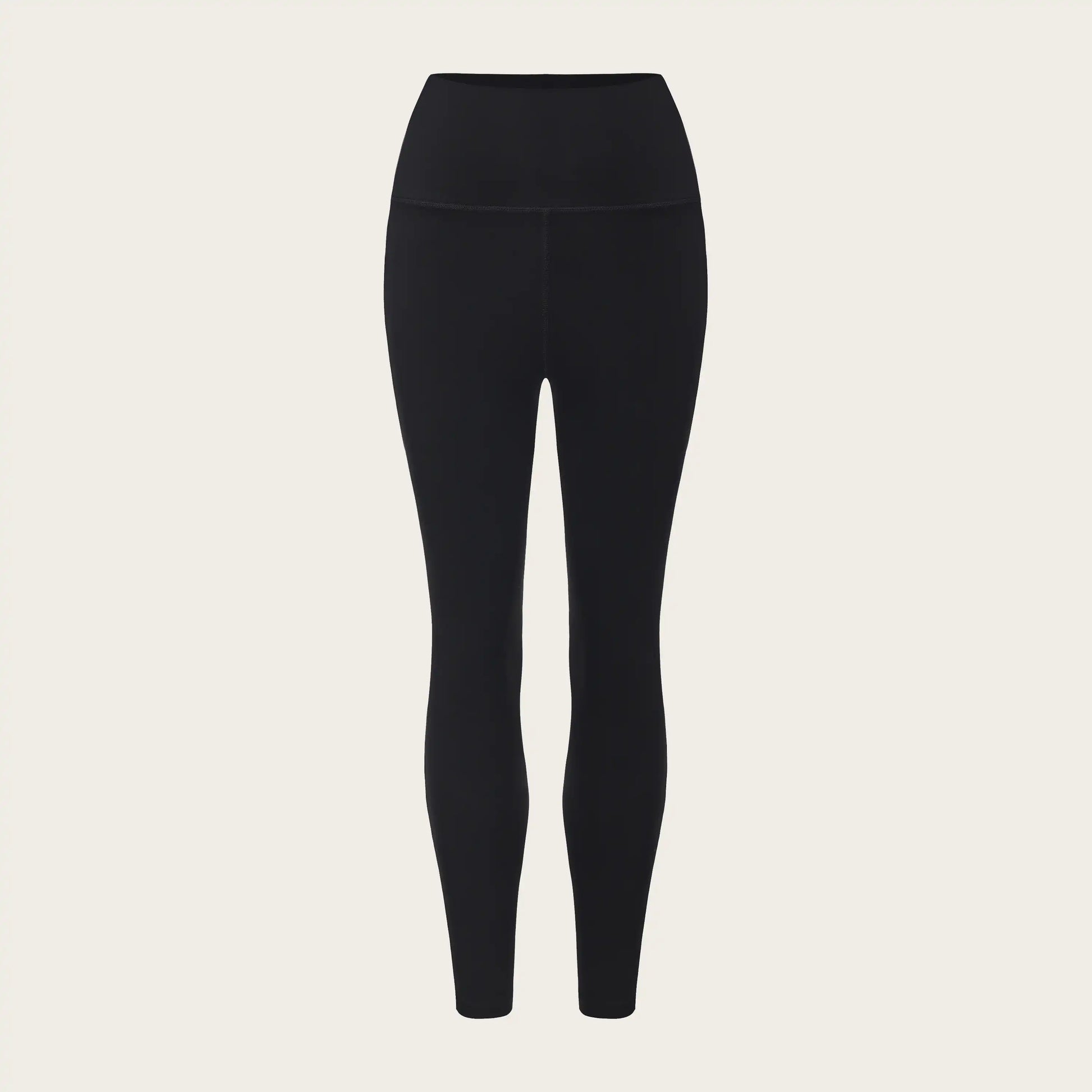 Black leggings on a beige background