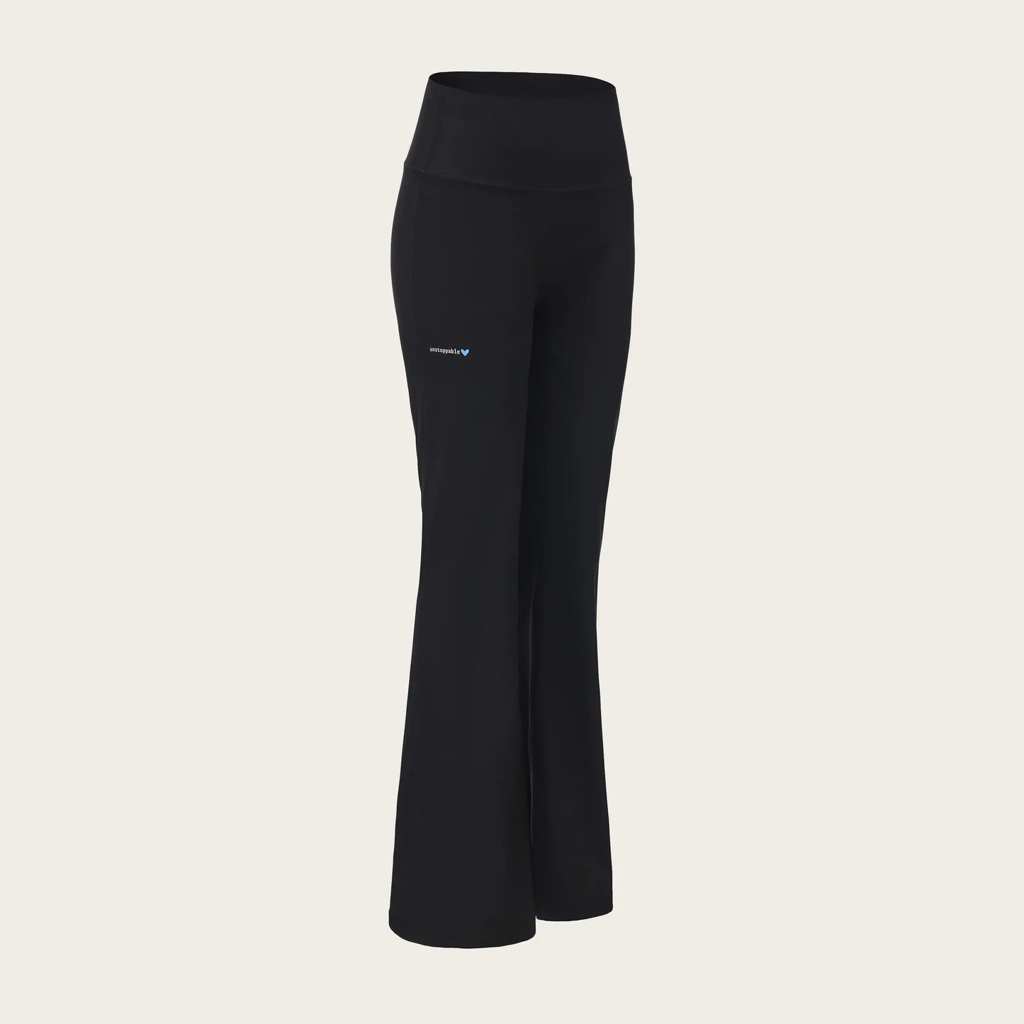 Black pants with a brand logo on a beige background