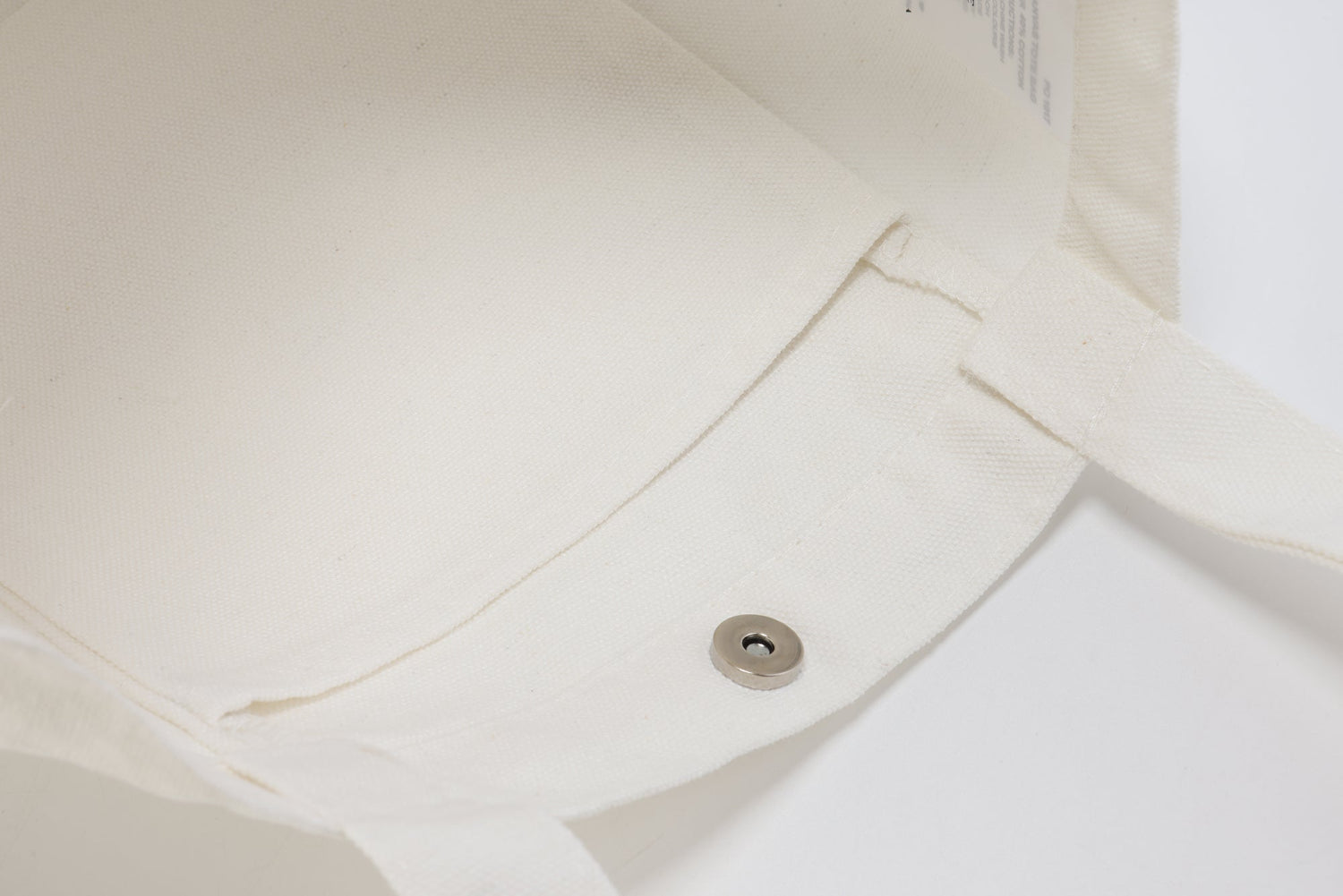 White canvas tote bag with a magnetic closure, perfect for wholesale or everyday use.