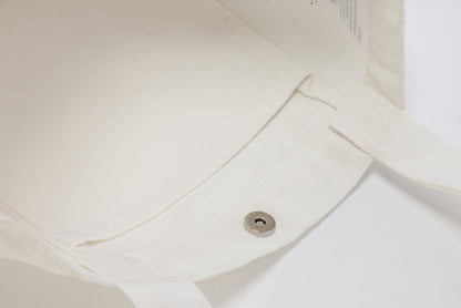 White canvas tote bag with a magnetic closure, perfect for wholesale or everyday use.