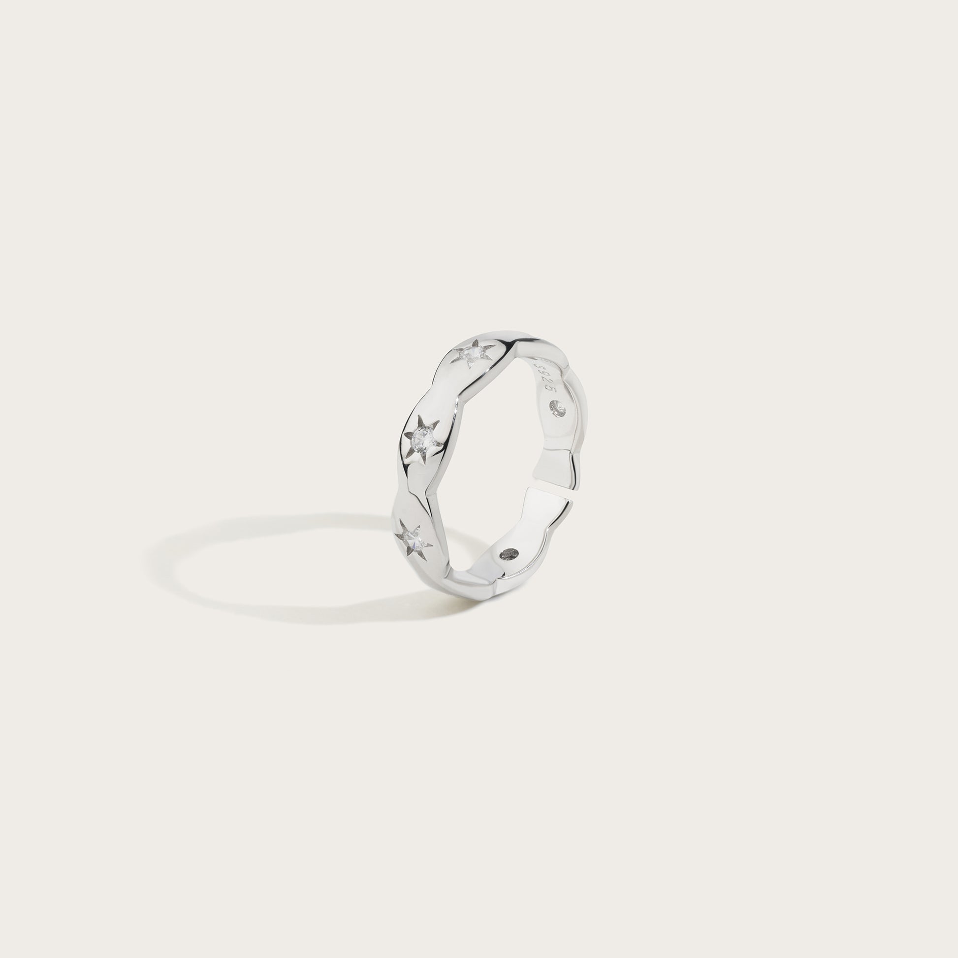 Silver ring with a unique design on a light gray background