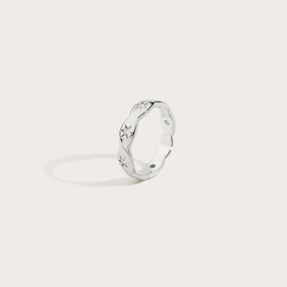 Silver ring with a unique design on a light gray background